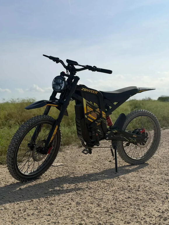 Zonveer ZX3 electric dirt bike parked on gravel before chain maintenance